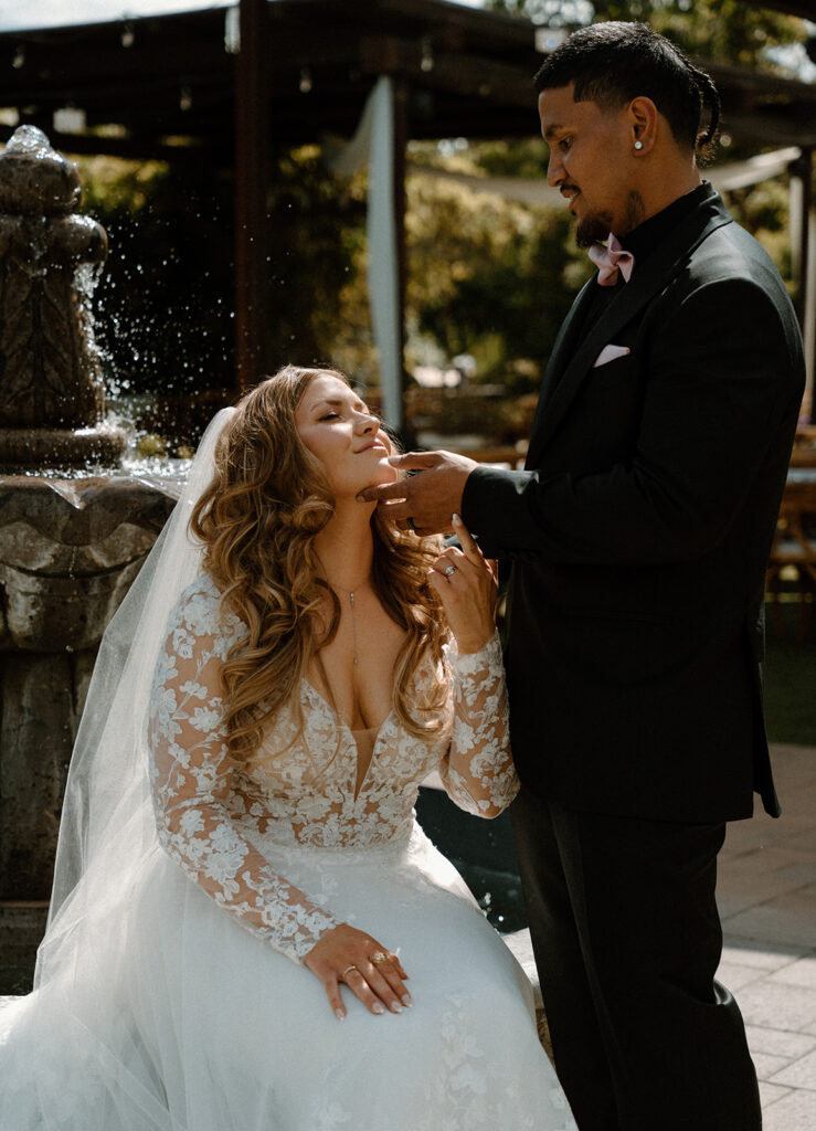 Couple surrounded by soft glittery light from the Las Cascadas fountain during wedding portraits