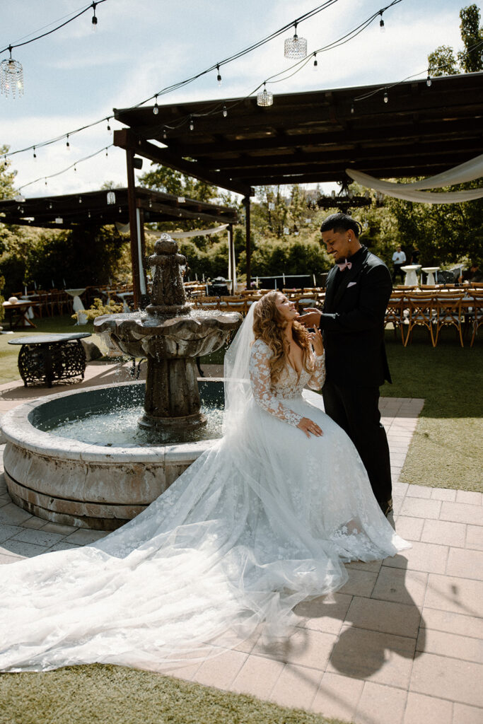 Bride and groom looking into each other's eyes with groom's hand on bride's chin