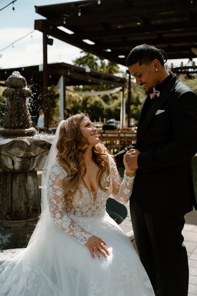 bride and groom smiling at each other during editorial pose at las Cascadas