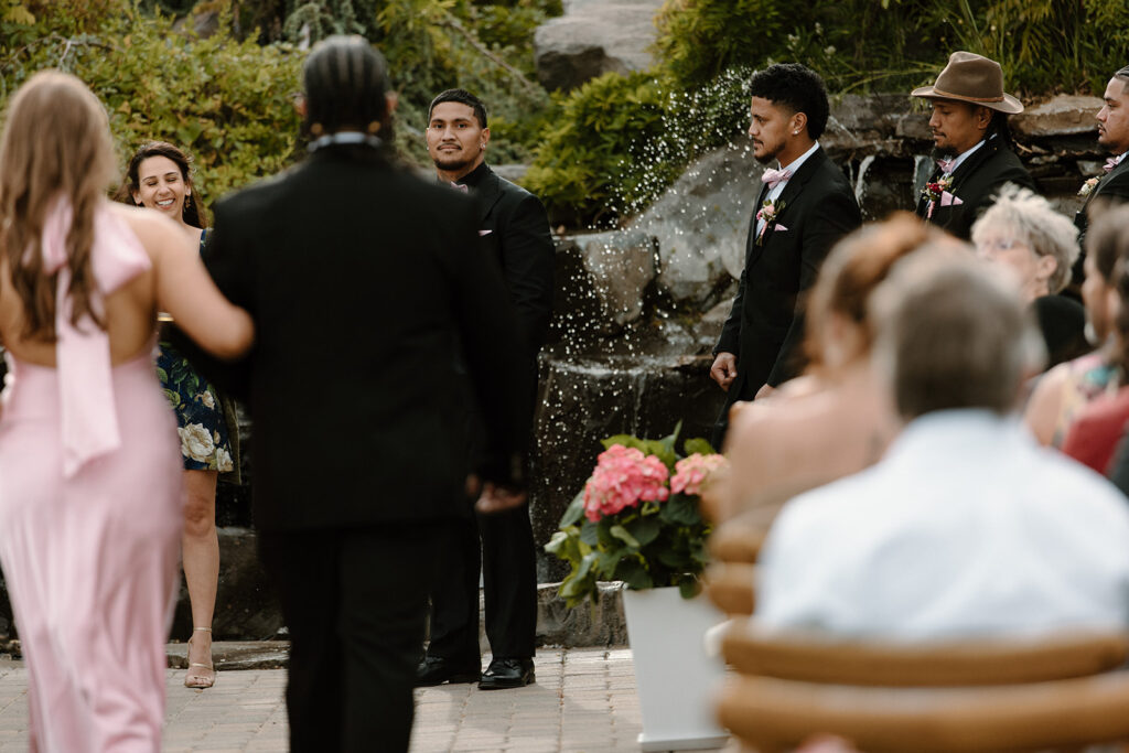 Groom emotional as he watches his bride walk down the aisle at Las Cascadas wedding venue in Reno Nevada