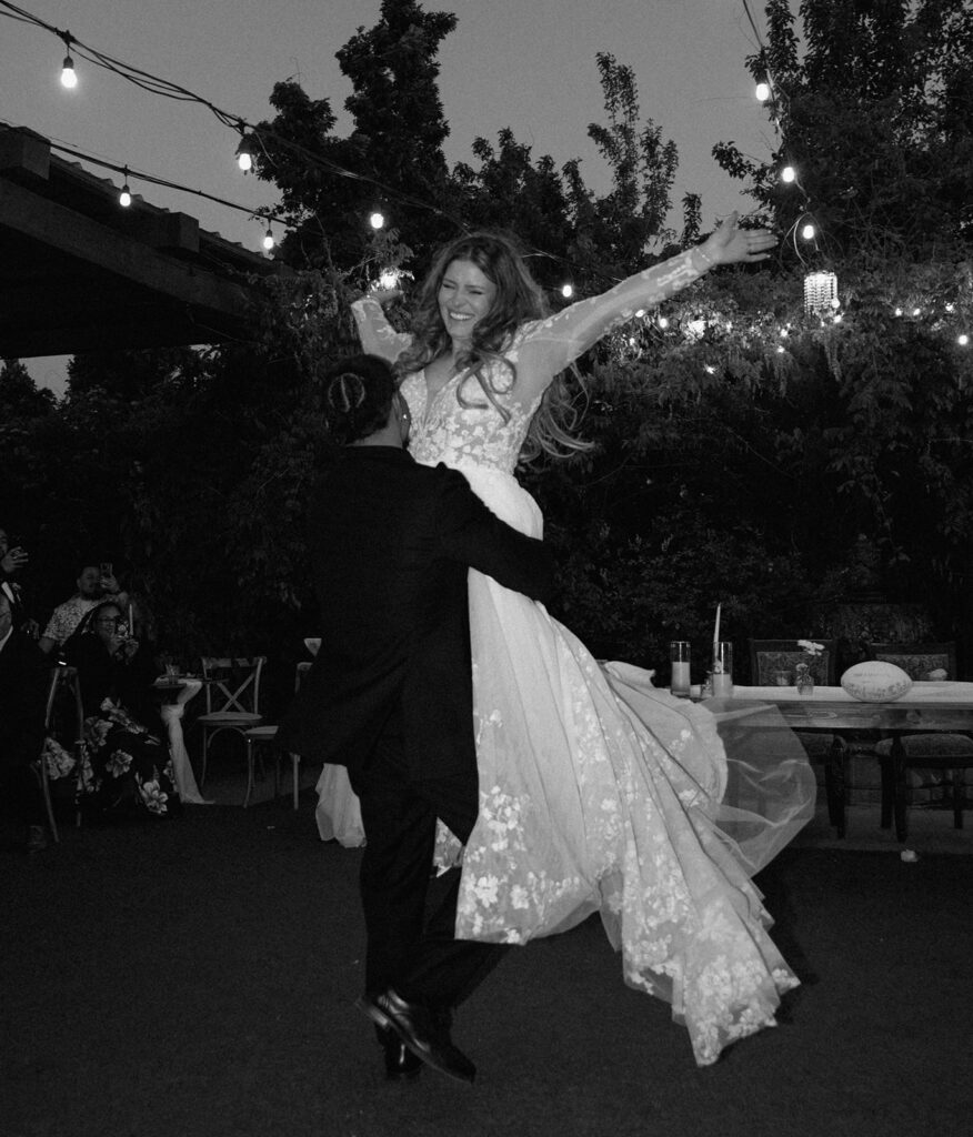 Bride and groom dancing under warm patio lights at Las Cascadas wedding venue in Reno Nevada