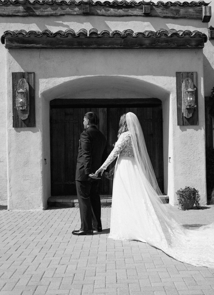 Bride and groom holding hands before the groom sees the bride